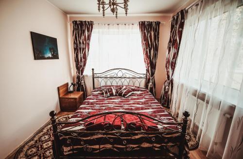 a bedroom with a bed in front of a window at Vorutos Terasa in Anykščiai
