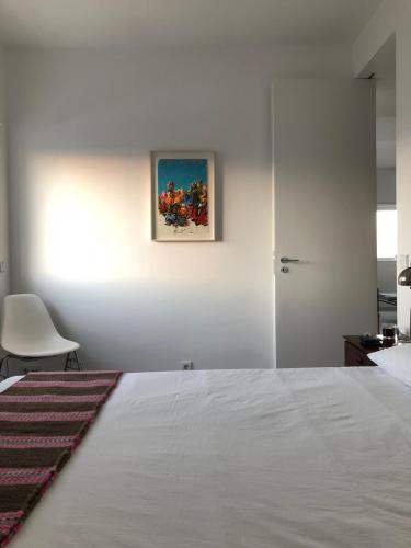 a bedroom with a bed and a painting on the wall at LUXURY ALVOR PENTHOUSE in Alvor
