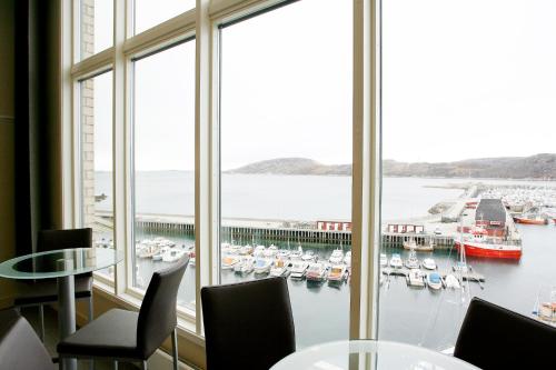 a room with a large window with boats in the water at Thon Hotel Nordlys in Bodø