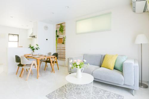a living room with a couch and a table at Andnext Holiday House in Kyoto