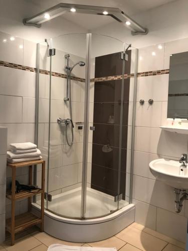 a bathroom with a shower and a sink at Pension Nordlicht in Norddeich