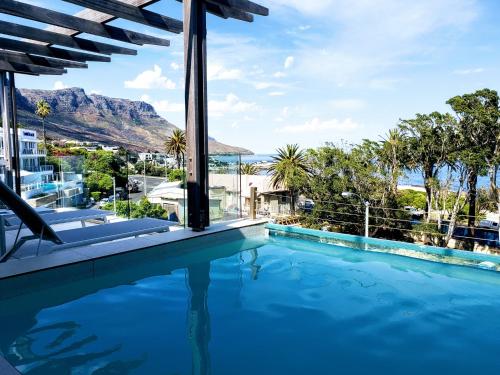 a swimming pool with a view of the mountains from a house at Blue Views Villas and Apartments in Cape Town