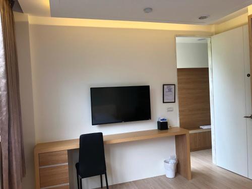 a living room with a television on a wall at Ming Yueju in Guoxing