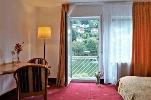 Postel nebo postele na pokoji v ubytování Hotel Neckarlux
