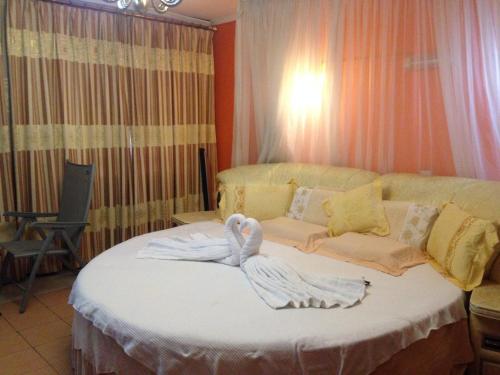 a bedroom with a bed with a swan on it at Chester View Homestay in Syokimau