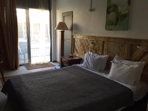 a bedroom with a large bed with white pillows at Villa Alizee in Port Louis