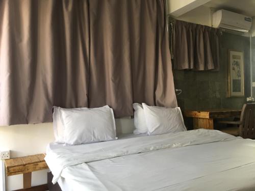a bedroom with two beds with white sheets and pillows at Villa Alizee in Port Louis