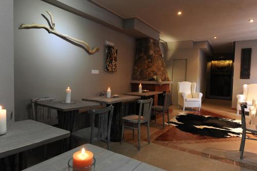 a restaurant with tables and candles on the wall at Posada Rural Bistruey in Potes