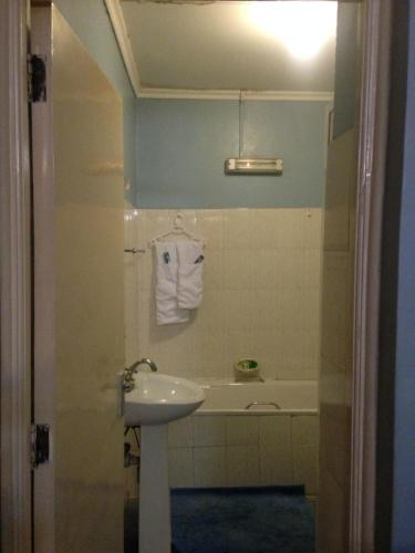 a bathroom with a sink and a bath tub at Chester View Homestay in Syokimau