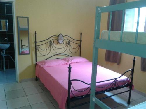 a bedroom with a bed and a bunk bed at Casa Praia Grande - Vila Caiçara in Solemar