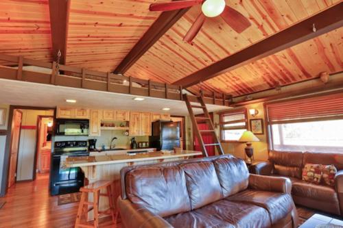 a living room with a leather couch and a kitchen at C1 in Carbondale