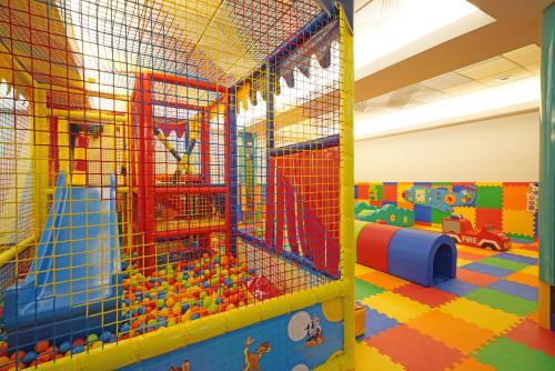 a play room with toys in a play structure at Hotel Caravel in Limone sul Garda