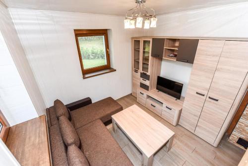 a living room with a couch and a table at Vacation Home Mezsargi in Pape