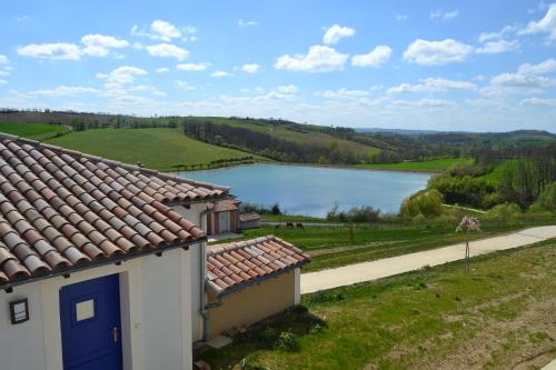 a house with a view of a lake at Résidence L'Oustal Del Carlat in Carla-Bayle