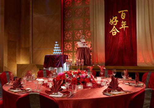 a table with red table cloth and flowers on it at Hotel Kuva Chateau in Zhongli