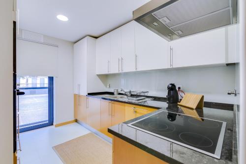 a kitchen with a sink and a counter top at Village Marina Olhão in Olhão