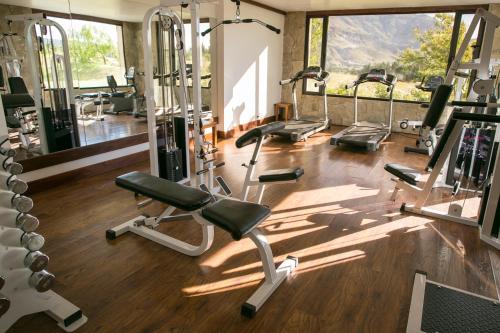 a gym with several tread machines in a room at Loi Suites Chapelco Hotel in San Martín de los Andes