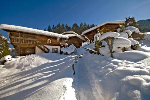 a pile of snow in front of a house at Ferienhäuser Reither Almen in Reith im Alpbachtal