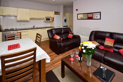 a living room with a couch and a table with flowers at Apartment 703 Letterfrack in Letterfrack