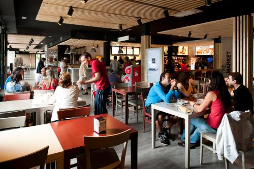 a group of people sitting at tables in a restaurant at AS Hoteles Altube in Zuia
