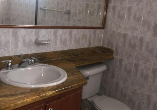 a bathroom with a sink and a toilet at Casa Quinta con piscina privada Girardot in Girardot