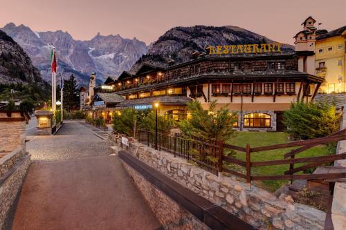 a building in front of a mountain at iH Hotels Courmayeur Mont Blanc in Courmayeur
