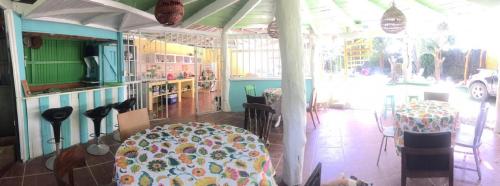 a restaurant with a table and chairs in a room at Madre Selva Hostel in Puerto Viejo