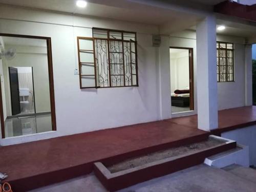 a house with two windows and a wooden porch at Delight Homestay in Cherrapunji