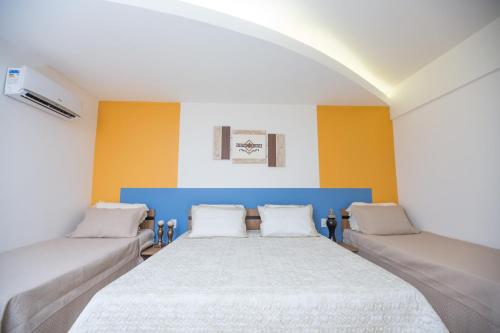 a bedroom with a large bed with two pillows at Prive Thermas - OFICIAL in Caldas Novas