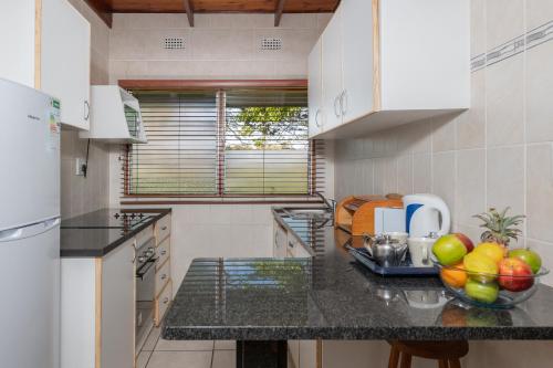 a kitchen with a bowl of fruit on a counter at Manzini Chalets in St Lucia