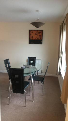 a dining room with a table with a laptop on it at Sandy bay 56 sunrise drive first floor apartment in Filey