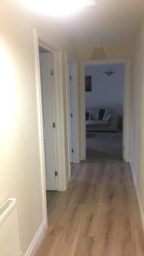 an empty room with a hallway with a bedroom at Sandy bay 56 sunrise drive first floor apartment in Filey