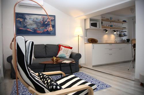 a living room with a couch and a table at Sweet Suite with free private parking in Pula
