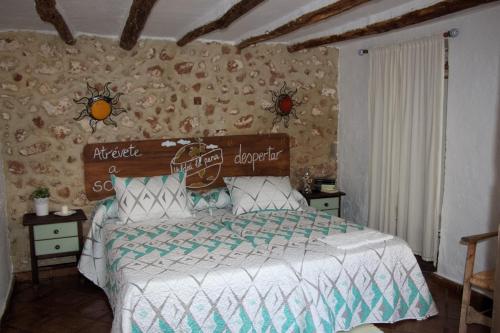 a bed with a white bedspread and pillows in a bedroom at La Carrihuela in Algodonales