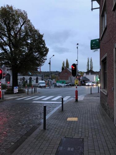 a street with a red traffic light on a street at House in Charleroi
