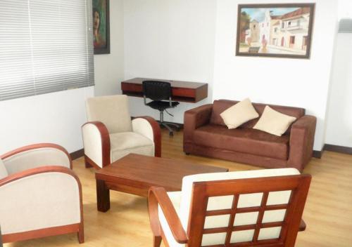 a living room with a couch and a table and chairs at Apartamento Amoblado en el Poblado Medellín Colombia in Medellín