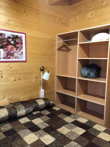 a room with wooden walls and shelves in a room at Càmping Molí de Vilamala in Les Planes d'Hostoles