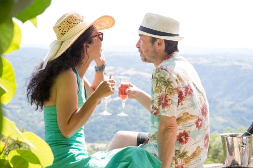 a man and woman drinking wine in the mountains at Art et Création in Saint-Bérain