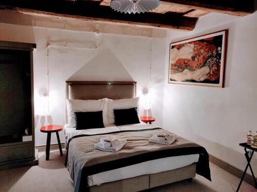 a bedroom with a bed with two towels on it at Hotel Kocour in Třebíč