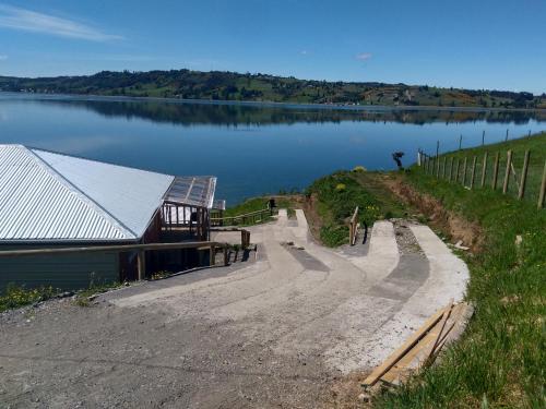 a building on the side of a lake at Cabañas Lomas de Ten Ten in Castro