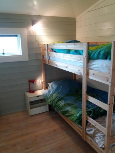 two bunk beds in a tiny house at Cozy Cottage in Warmenhuizen