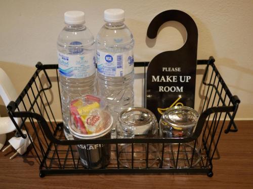 a basket with two bottles of water and other items at Let's Zzz Bangkok in Bangkok