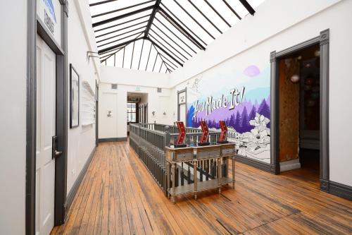 a hallway with red chairs on a wooden floor at Hostel Fish in Denver