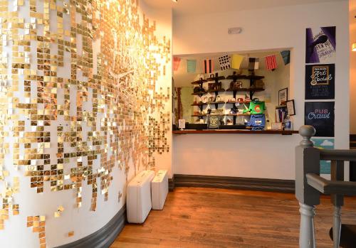 a room with a wall covered in many magnets at Hostel Fish in Denver