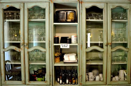 a cabinet filled with lots of glasses at Casa Rural Molí de Fòrnols in Fornols