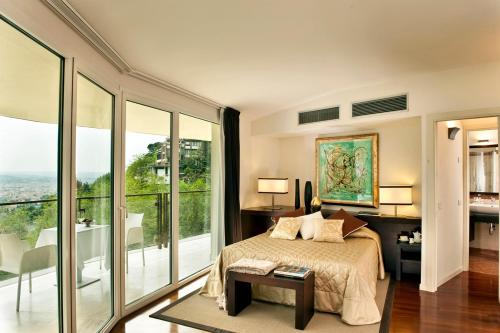 a bedroom with a bed and large glass windows at Eden Rock Resort in Florence