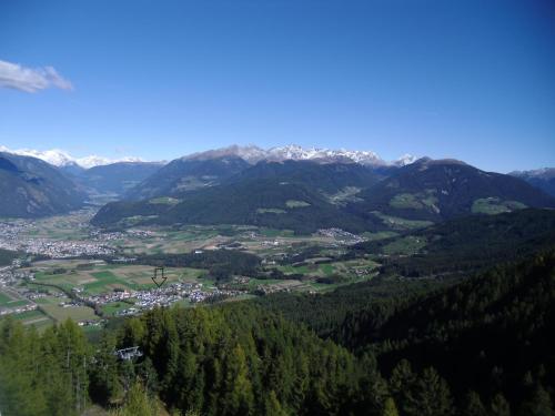 a view of a town in a valley with mountains at Krebslechnerhof in Brunico