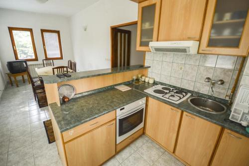 a kitchen with a sink and a stove top oven at Vila Gardenia in Sarajevo