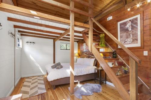 a bedroom with a bed and a staircase in a room at Blue Apple Lodge in Bilpin