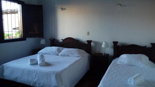 Ένα ή περισσότερα κρεβάτια σε δωμάτιο στο Hotel Casa Claustro De Zapatoca